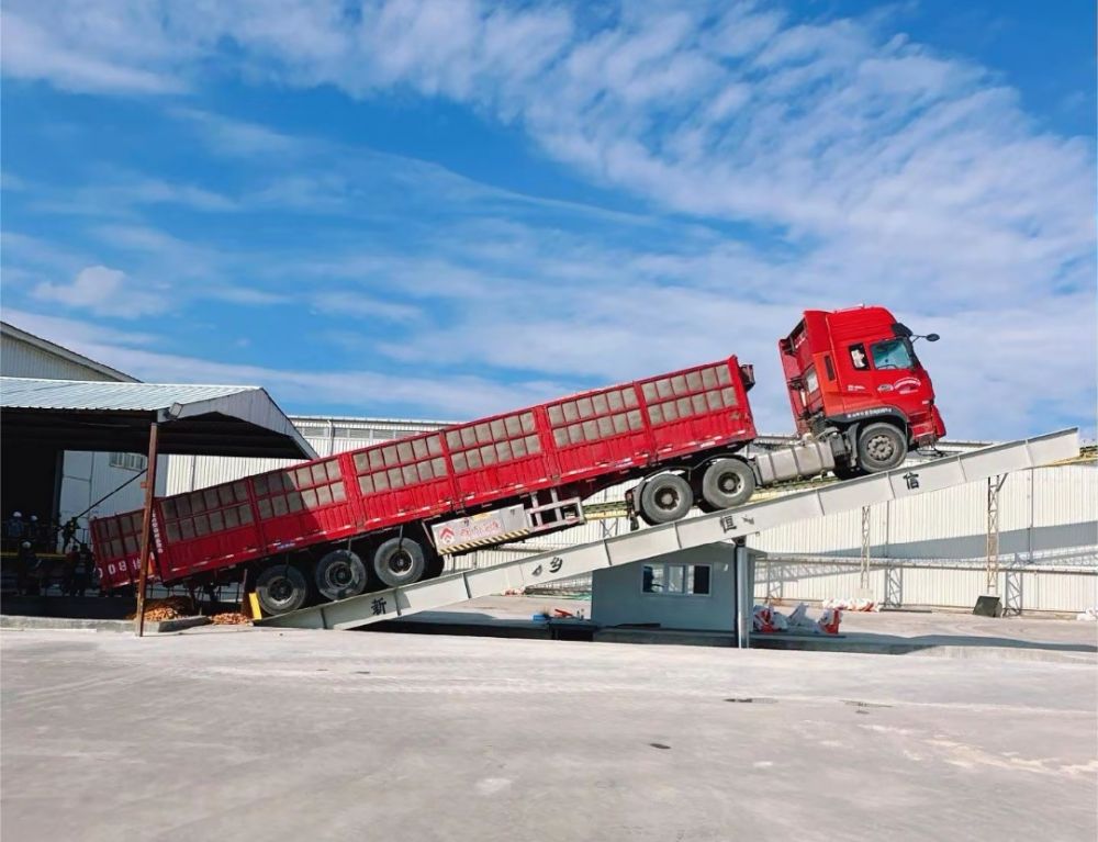 液壓卸車機、后翻式液壓翻板卸車平臺、河南愛信液壓翻板機